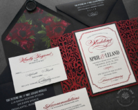 Red Laser Cut Invitations with ornate filigree folder, black envelopes lined with moody burgundy floral print