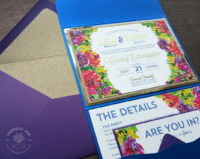 Vibrant Floral Pocket Invitation with multicolored rainbow flowers in a royal blue folder with purple envelopes and gold glitter liners