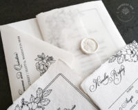 Black Floral Sketch Invitation with line art flowers, hand-torn edges and translucent vellum wraps