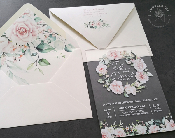 Floral Wreath Acrylic Invitation with light blush pink flowers on a clear card.