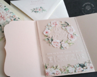 Floral Wreath Acrylic Invitation with light blush pink flowers on a clear card.