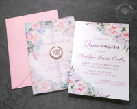 Pastel Floral Quinceañera Invitation with shades of pink, purple, and blue flowers, with Pink foil text and translucent vellum wraps