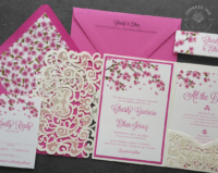 Fuchsia Cherry Blossom Invitation with bright pink flowering branches and a shimmery cream laser cut lace pocket folder.