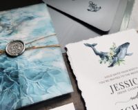 Watercolor Whale Nautical Invitation with hand-torn edges, ocean pattern vellum wraps with ship wheel wax seals