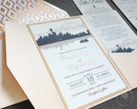 Blush Seattle Skyline Invitation with navy blue city silhouette, mounted inside a pocket folder