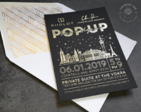 Gold Las Vegas Invitation with foil imprint on black cardstock and line art silhouette of city skyline