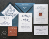 Modern Script Letterpress Invitation with bold names in navy letterpress imprint, slate envelopes with floral line art print, pops of rust orange