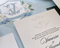 Debossed Monogram Floral Invitation with Azure blue envelopes lined with a blue floral crest
