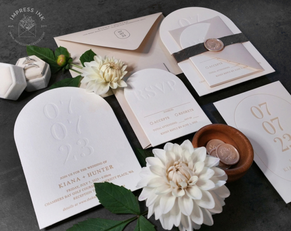 Debossed Date Arch Invitation with letterpress wedding date and beige text and envelopes