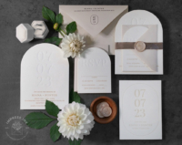Debossed Date Arch Invitation with letterpress wedding date and beige text and envelopes