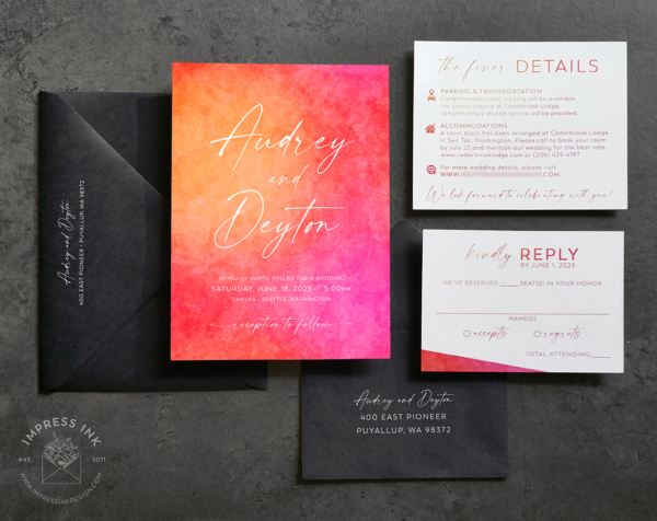 Bright Sunset Watercolor Invitation in shades of hot pink, bright red, and tangerine orange, with modern fonts and black envelopes