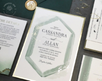Green Geometric Watercolor Invitation with hexagon frame and splatters of gold foil, evergreen envelopes and gold wax seals
