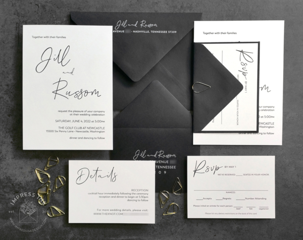 Modern Minimalist Black Invitation set with white cards printed in a casually modern black text, black envelopes with white ink printing, and gold teardrop paperclips