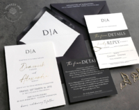 Black Modern Monogram Invitation printed in modern fonts, pops of gold foil, black envelopes with white ink printing, and gold teardrop paperclips