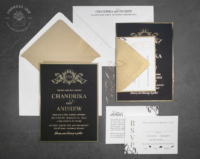 Ornate Gold Monogram Invitation on matte black cardstock with gold foil imprint and backing layer