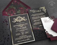 Moody Ornate Monogram Invitation in gold foil on matte black cardstock with burgundy florals and laser cut lace pocket folder