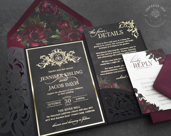 Moody Ornate Monogram Invitation in gold foil on matte black cardstock with burgundy florals and laser cut lace pocket folder