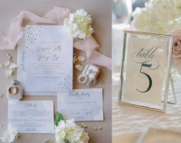 Silver Whimsical Watercolor Invitation with light blue textured background and silver foil imprint with confetti embellishment on the corners, shown with table number signs