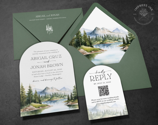 Watercolor Mountain Wilderness Invitation with Cascade inspired watercolor landscape on an arch-shaped card with green envelopes